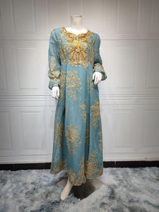 Close-up of golden embroidery and sequins on the grey-blue Kaftan party dress