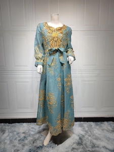 Exquisite gold floral embroidery and sequins on the neckline of a blue evening dress