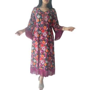 Ethnic bohemian long dress with vibrant floral gold printing and purple tassel trim details