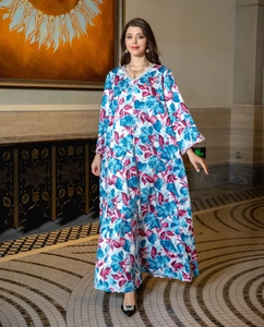 Detail of the elegant V-neckline with silver rhinestone embellishment on the floral kaftan