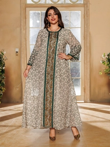Close-up of gold sequin embroidery and green geometric patterns on beige kaftan dress