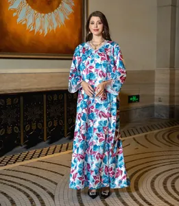 Detail of bohemian floral maxi dress featuring V-neckline with shimmering sequin trim detail