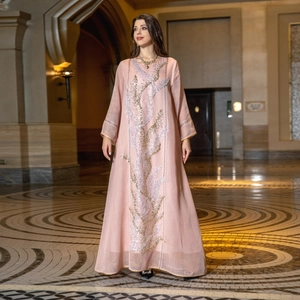 Elegant pink maxi kaftan dress with sequin leaf embroidery, presented by a model.