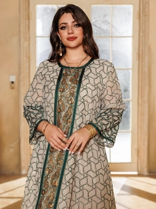 Close-up of golden embroidery and sequins on this elegant long sleeve kaftan dress