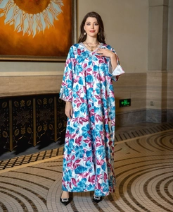 Detailed view of sequined V-neckline and vibrant floral print on satin maxi dress