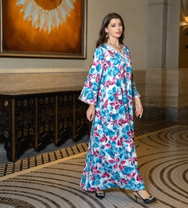 Detail of V-neckline with sequins and floral print on long sleeve chiffon dress