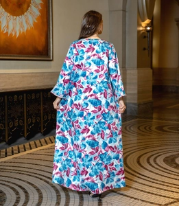 Back view of bohemian floral maxi dress with vibrant blue and red prints on white fabric