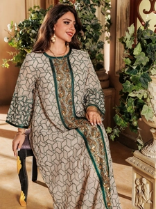 Detailed close-up of golden embroidery and sequins on this elegant long mesh dress