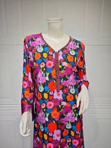 Close-up of ethnic V-neck maxi dress featuring floral gold stamping and purple silk tassels
