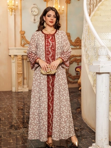 Detail of sequin embroidery and intricate mesh patterns on an elegant long-sleeve kaftan