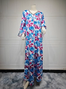 Detail of floral printed kaftan dress with sparkling rhinestone V-neckline embellishments