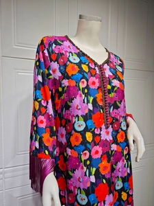 Close-up of V-neck ethnic long dress with gold floral print and purple beaded details