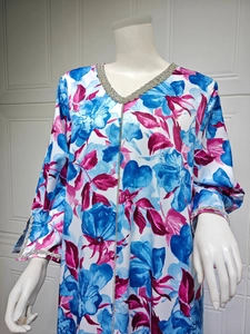 Deep V-neck kaftan dress detail with silver rhinestone trim and floral print