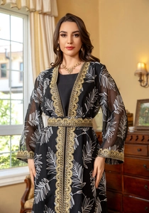 Detail of intricate gold embroidery on black mesh fabric of ethnic two-piece set