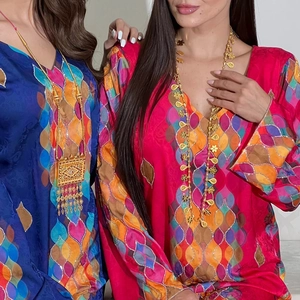 Elegant long-sleeved kaftan dress with colorful wave print and gold ethnic necklace