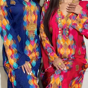 Detailed close-up of ethnic V-neck dress with vibrant geometric patterns and sequins