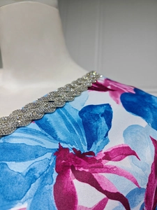 Detailed macro view of the floral print neckline with silver rhinestone embellishments
