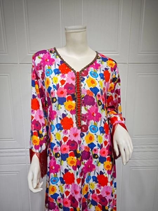 Close-up of ethnic V-neck maxi dress with gold floral prints and beaded details