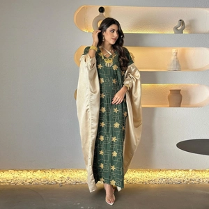 Elegant dark green abaya with gold floral embroidery and beige silk overlay set