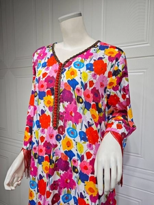 Detailed V-neck floral print dress with bronze braided trim and red tassel sleeves