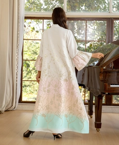 Detail of pink and green gradient dress with gold floral embroidery on the back and ruffled sleeves