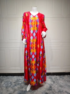 Detailed view of the V-neckline and geometric diamond print on a red maxi dress