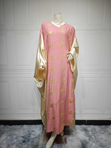 Detail of pink embroidered Kaftan dress showing gold floral patterns and satin sleeve cuffs