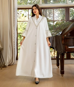 Detail of silver embroidery on V-neckline and bell sleeves of white modest maxi dress