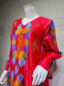 Detail of red floral print dress with V-neckline and sparkling rhinestone embellishments