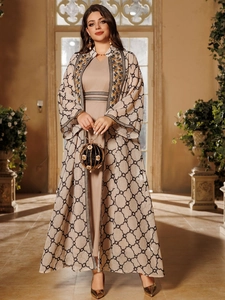 Details goldener Blumenstickereien und Karomuster auf einem beigen Abaya-Gewandset