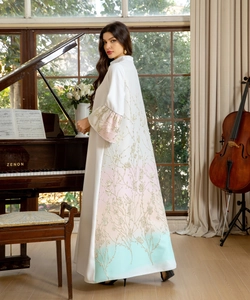 Detailed view of white abaya sleeve with gold floral embroidery and pastel gradient tint