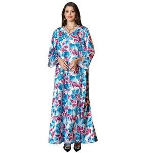 Elegant white long sleeve kaftan dress featuring vibrant blue and purple floral patterns