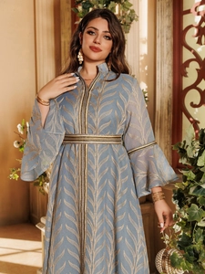Detail of grey-blue kaftan dress with golden leaf embroidery and flared sleeves