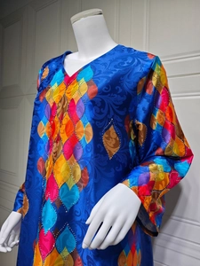 Detailed view of the V-neck with colorful geometric patterns and silver rhinestones