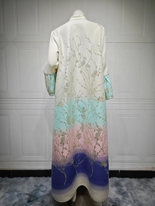 Detail of gradient abaya with intricate golden floral embroidery on satin fabric