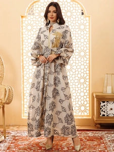 Detail of the golden phoenix embroidery and retro leaf patterns on a Jalabiya maxi dress