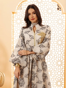 Detailed view of gold leaf embroidery and zipper on long sleeve printed jalabiya dress