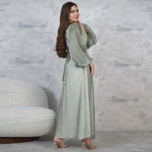 Detail of sage green maxi dress featuring elegant puff sleeves and sparkling rhinestone accents