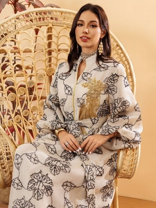 Detailed close-up of golden sequin embroidery and leaf print on long jalabiya dress