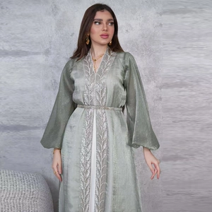 Detail view of sage green long dress featuring elegant silver leaf sequin embroidery