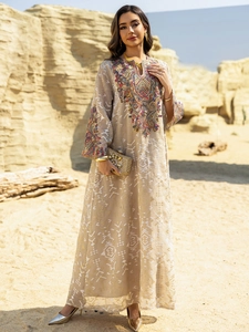 Detailed view of colorful ethnic embroidery and geometric jacquard on a long mesh dress