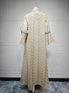 Detail of champagne Abaya with gold leaf embroidery and flared sleeves on model