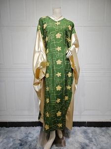 Detailed embroidery and contrast stitching on this elegant green and gold satin abaya