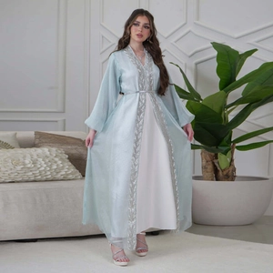 Detail of silver leaf embroidery and sequins on light blue long sleeve caftan kaftan