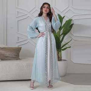 Detail of silver leaf embroidery on light blue puff sleeve abaya with rhinestone accents