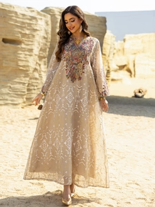 Detailed view of colorful embroidery on light champagne ethnic mesh maxi dress in desert