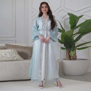 Detail of silver leaf embroidery on light blue tulle kaftan and white inner dress