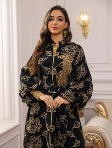Detailed embroidery of gold leaves and birds on a black Jalabiya evening dress