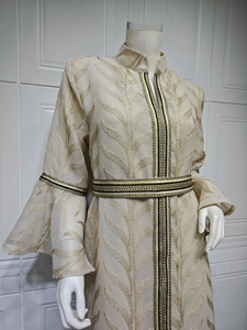 Detail of elegant champagne embroidery on flared sleeve and ethnic braid trim