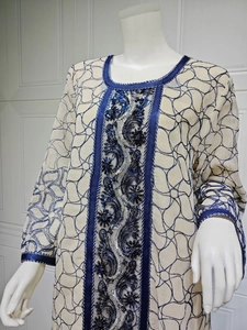 Detailed blue sequin embroidery and vine patterns on white mesh long sleeve dress